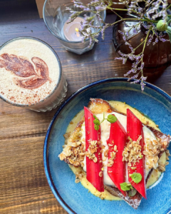 A photo from above of rhubarb french toast and speciality coffee.