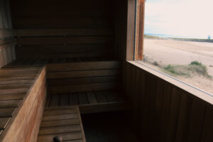 Two-tiered sauna benches that overlook Porthcawl’s beautiful Sandy Bay.