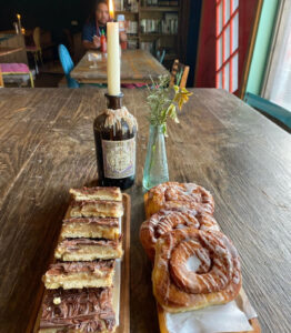 Baked goods and a cadle on a wooden table