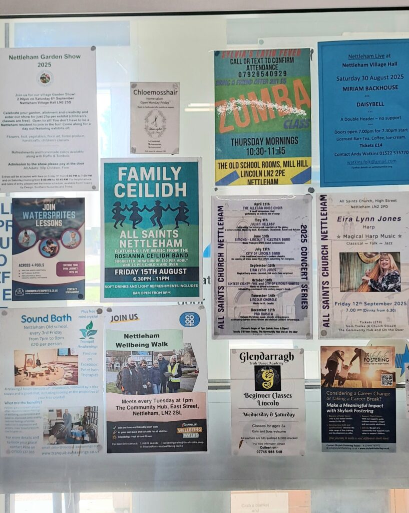 Photograph of a noticeboard display at Nettleham Community Hub. Many brightly coloured flyers can be seen advertising local events.